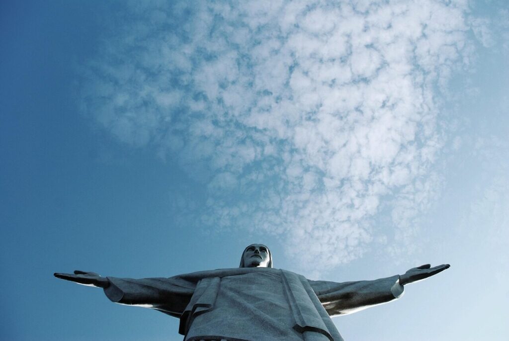 Christ the Redeemer statue on Corcovado mountain rising above clouds