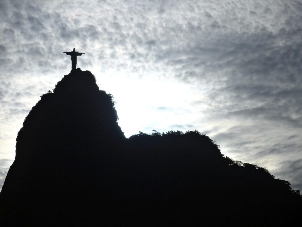 Christ the Redeemer statue partly hidden by thick cloud on top of Corcovado
