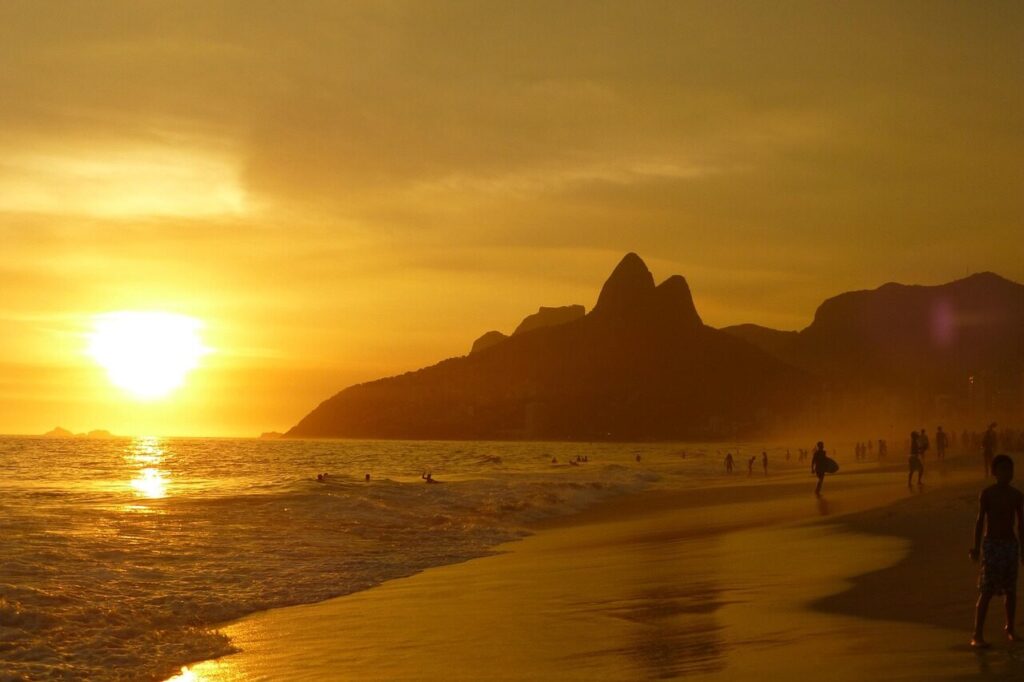 Ipanema beach at sunset with the Two Brothers mountain rising behind the sand