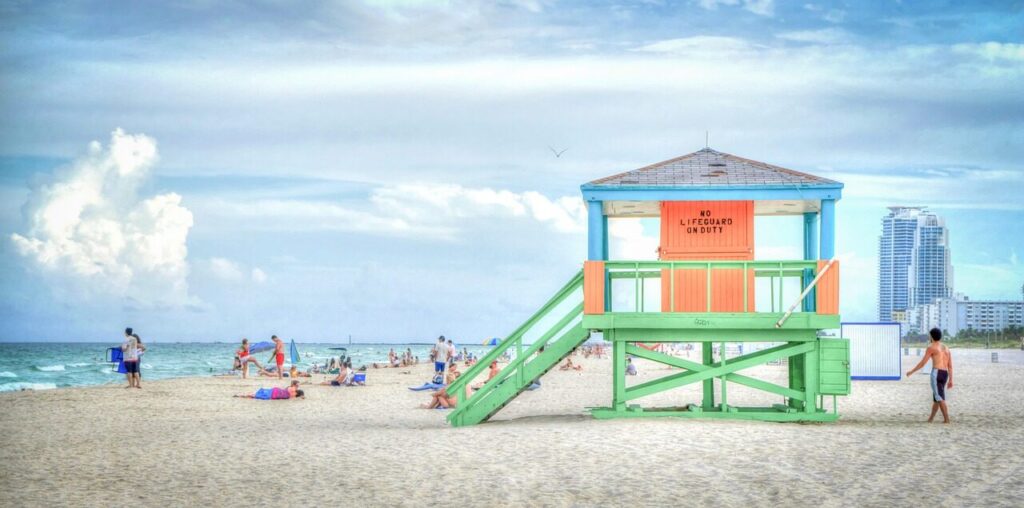 Lifeguard tower on Copacabana beach with swimmers and umbrellas along the sand