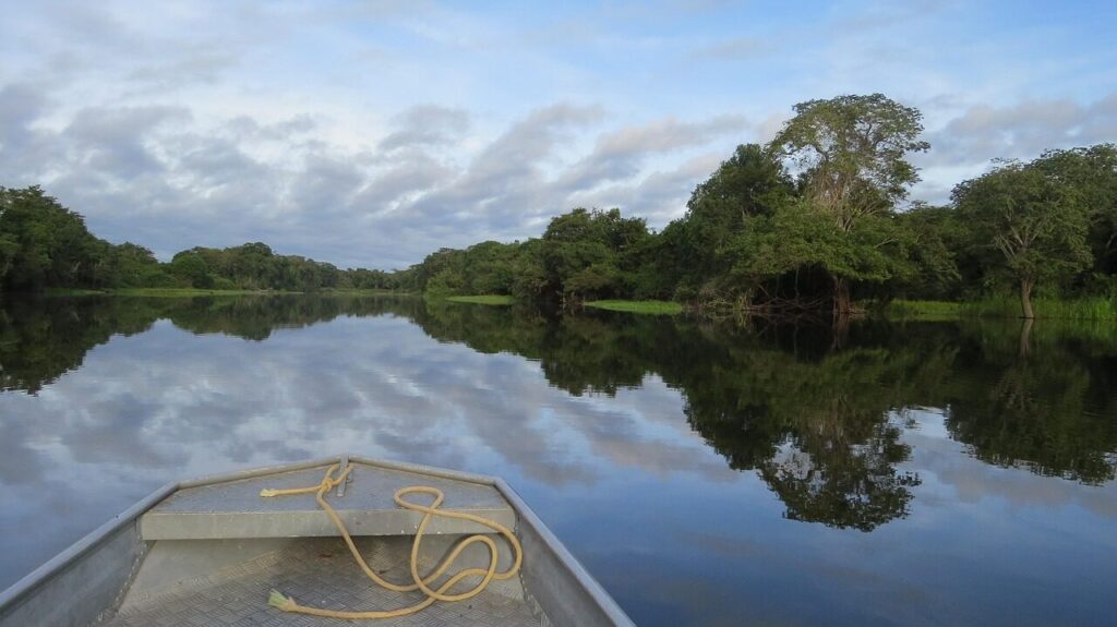 Passengers resting in hammocks on the deck of a riverboat on the Amazon