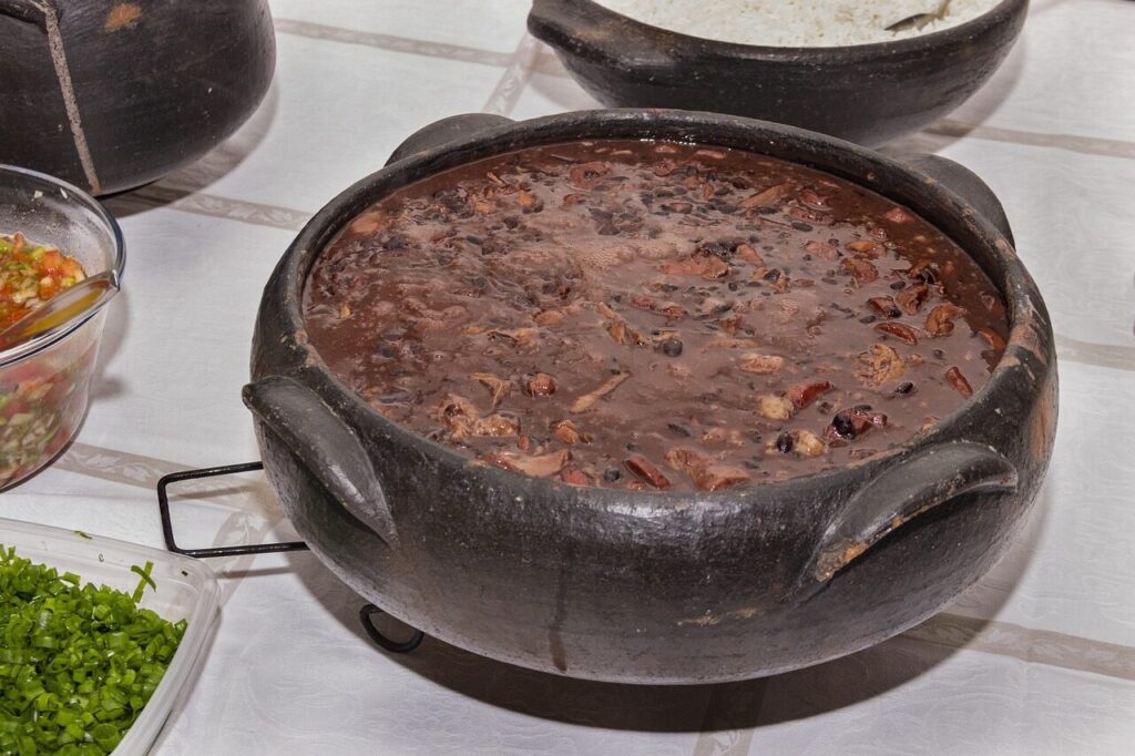 Plate of feijoada black bean stew with rice and orange slices