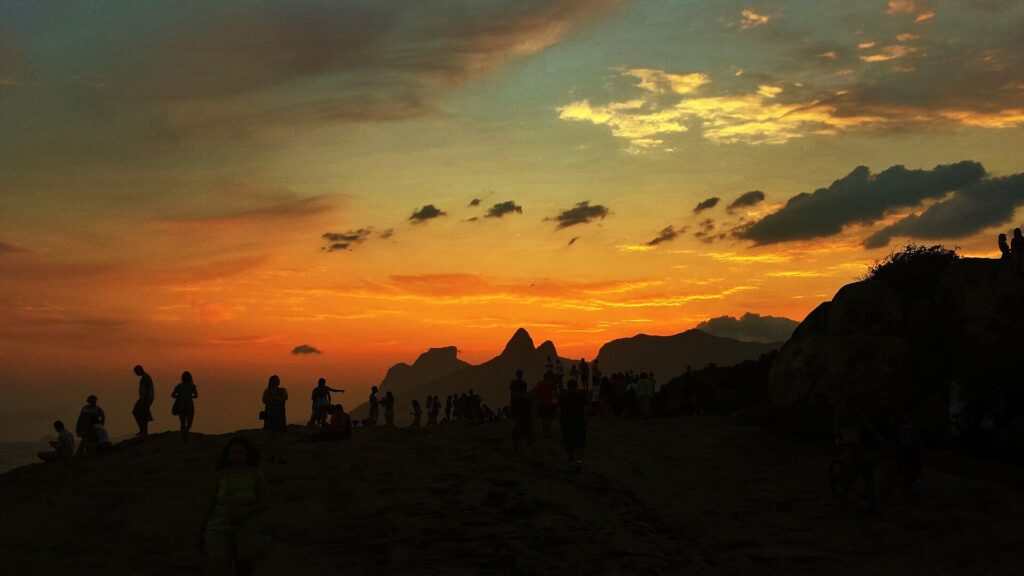 Sunset crowd on the Arpoador rock beside Ipanema beach in Rio