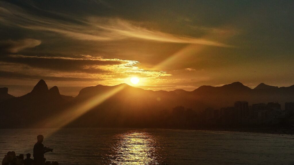 Sunset over Ipanema beach seen from the rocks at Arpoador