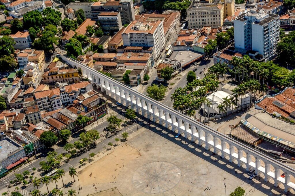 The white Arcos da Lapa aqueduct lit up at night in central Rio